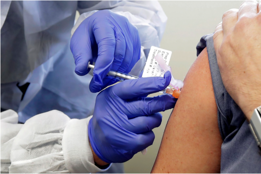 The COVID-19 vaccination being administered to a patient. 