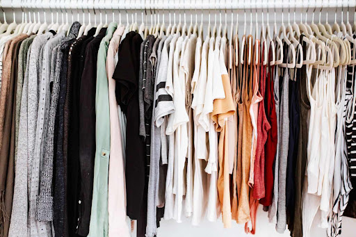 Image of various pieces of clothing hanging on a rack.