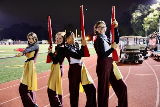 Sam Eldred and her fellow color guard members hold their rifles. From left to right: Sara Bykov, Samantha Eldred, Natalie Byers, and Meredith Roughgarden.
