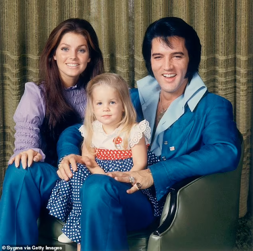 Priscilla Presley and Elvis Presley with a young Lisa Marie Presley.