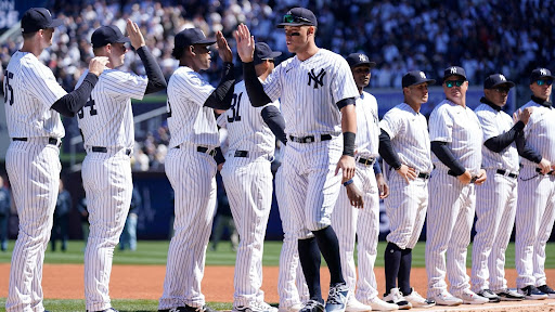 Aaron Judge High-fiving Teammate Willie Calhoun on Opening Day. Photo Source: Espn.com.
