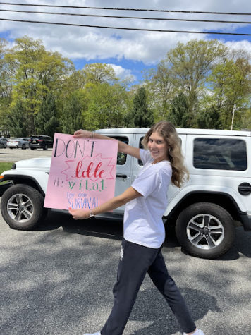 Erin Freeman holding up a campaign sign. Photo Source: Anthony Dabrowski
