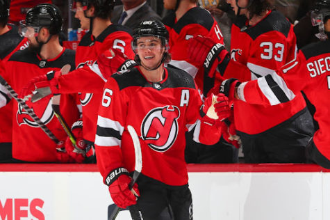 Devils’ Jack Hughes fistbumping his bench before a game. 