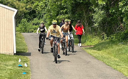 Coach Burton and some interested students trying the mountain bikes at Pochella.