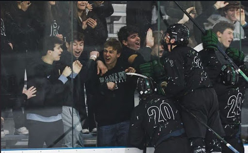 The boys celebrate with the student section after a goal (@ramapoicehockey Instagram)