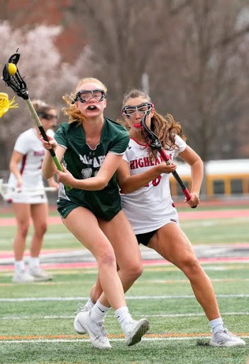 Caroline holds the ball with a Northern Highlands player behind her. (NJ.com)