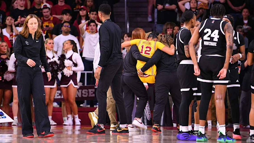 JuJu Watkins assisted off of the court (ESPN)
